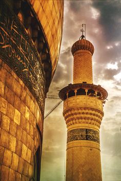 two tall towers with writing on them against a cloudy sky