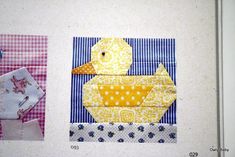 the quilts are laid out on the wall next to each other, including one ducky