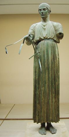 a statue of a woman with scissors in her hands