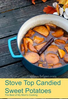 a pot filled with stew sitting on top of a wooden table next to autumn leaves