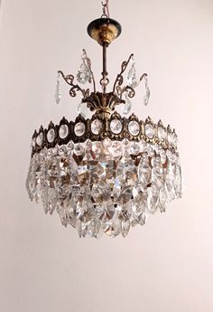 a chandelier hanging from the ceiling with lots of crystal beads on it's sides