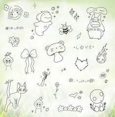 various cartoon animals and other things drawn on a sheet of paper with grass in the background