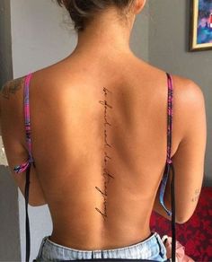 the back of a woman's body with writing on it