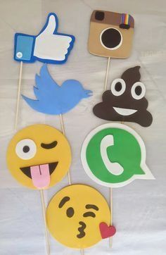 some stickers that are shaped like facebook and emotictive smiley faces on sticks