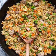 a skillet filled with rice and vegetables