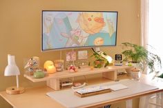 a flat screen tv sitting on top of a wooden desk next to a lamp and potted plant