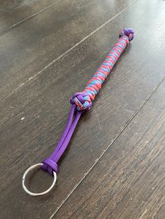 a purple and red paracorine on a wooden floor with a metal ring attached to it