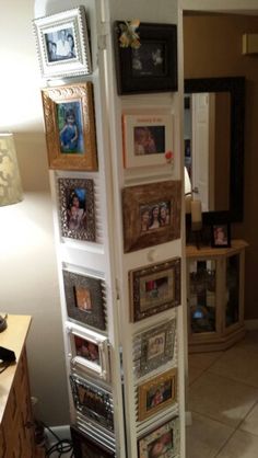 a tall white cabinet with pictures on it's sides and drawers in the middle