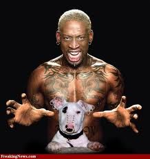 a man with tattoos on his chest holding a white dog in front of him and the caption says,