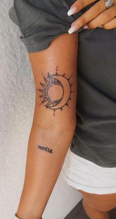 a woman with a sun and moon tattoo on her arm