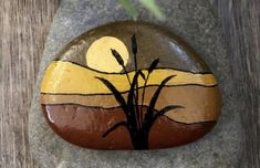 a painted rock sitting on top of a wooden table