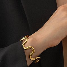 Surf's up with the Ride that Wave cuff! Made with 18K gold plating, this bold statement bracelet won't tarnish. Catch a stylish wave with this non-tarnish cuff that adds an edgy touch to any outfit. 18K Gold Non-Tarnish Wavy Bold Statement Bracelet 18K Gold Plated Stainless Steel Measurement (Max Diameter inch): 2.5 Opening width (inch): 1.6 Manifest bravery and growth through any challenge or obstacle. Summer Book Club, Bridal Business, Barware Accessories, Holiday Maxi Dress, Native Shoes, Pin Doll, Crop Top Sweatshirt, Stroller Accessories, Curvy Dress