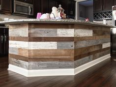 a kitchen island made out of wood planks