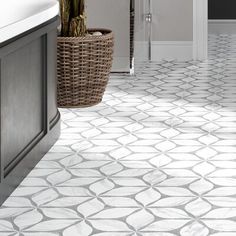 a bathroom with white and gray tile flooring