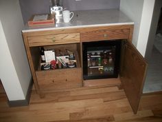 a small wooden cabinet with some items in it