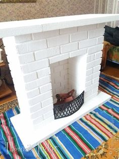 there is a fireplace in the middle of a room with colorful rugs on the floor