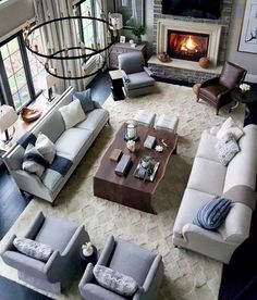 a living room filled with furniture and a fire place in the middle of the room