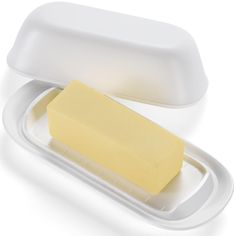 a yellow soap bar in a plastic container on a white surface with lid and handle