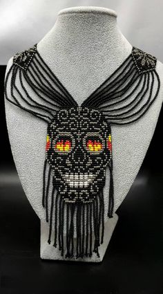 A very Beautiful  Handmade Skull Necklace  . Every beads  speak his own wonderful art . All seeds are very carefully threaded. We are sure this beautiful necklace enhance your beauty even more . Earring is with Necklace. Measurements. 50 cm long. width of chain 3cm. skull face width 5.5 cm  and length 14 cm. and.  Earring is 10 clong  and width 2.5 cm. Bohemian Beads With Bead Caps For Gifts, Day Of The Dead Beaded Jewelry Gift, Multicolor Bohemian Skull Jewelry, Handmade Bohemian Halloween Necklace, Unique Handmade Skull Necklace, Halloween Festival Jewelry With Black Beads, Halloween Festival Black Beaded Jewelry, Bohemian Skull Shaped Necklace For Gift, Bohemian Skull Necklace For Gifts