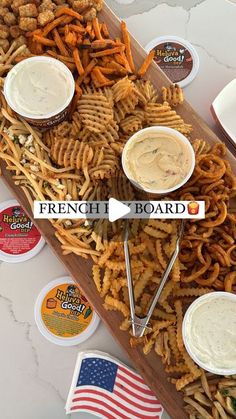 french fries and dips on a wooden platter with american flags in the background