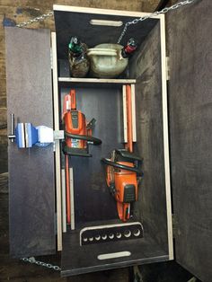 an open cabinet with tools in it