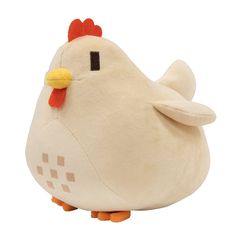 a white stuffed chicken sitting on top of a pillow