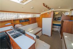 the interior of a sailboat with wood paneling