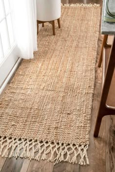 an area rug on the floor in front of a window