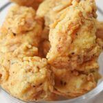 some fried food in a glass bowl on a table