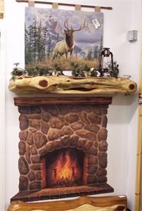 a fire place with a deer painting on the wall