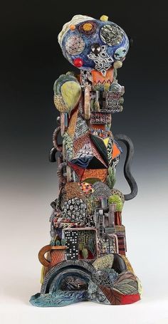 a sculpture made out of many different types of items and colors on it's sides