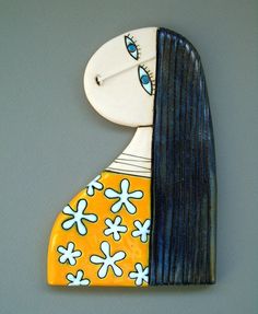 a ceramic painting of a woman with long hair