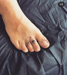 a person with two small tattoos on their feet and one has a flower tattoo on her left foot