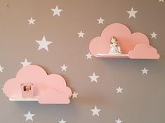 there are two shelves with clouds and stars on them