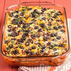 a casserole dish filled with black olives and cheese