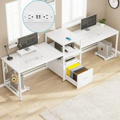 a white computer desk with two computers on it and a clock in the corner next to it