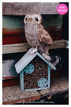 an owl sitting on top of a bird house