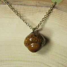 Hand crafted by JonnyB'sArt this necklace is a real acorn nut that is processed and suspended from a 24-inch gold plated base metal chain. Acorn Measures: 1" Tall - .75" Wide A one-of-a-kind piece of fashion jewelry! Acorn Crystal Necklace, Acorn Necklace, Base Metal, Metal Chain, Crystal Necklace, Gold Plate, Fashion Jewelry, Plating, Chain