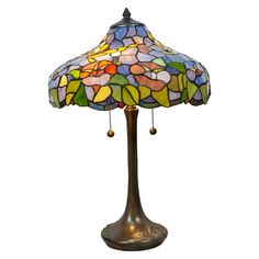 a stained glass lamp on a metal stand