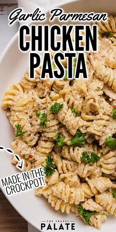 chicken pasta in a white bowl with parsley on top and the text garlic parmesan chicken pasta made in the crockpot