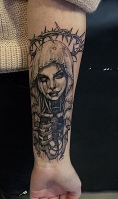 a woman's arm with a tattoo on it and a skull in the middle