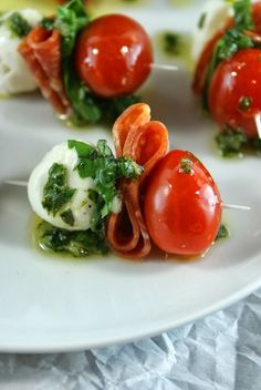 small appetizers with tomatoes, mozzarella and broccoli on a white plate