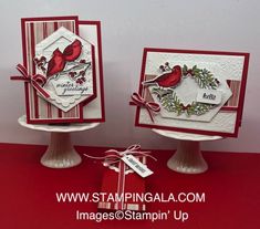 two cards with red birds on them sitting on top of each other in front of a white wall