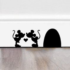 mickey and minnie mouse silhouettes in front of a door with the word love written on it