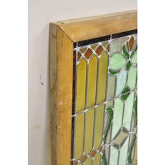 an old stained glass window hanging on the wall