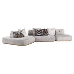 a large sectional couch with pillows on the top and bottom, sitting in front of a white background