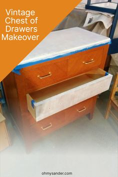 an old dresser is painted white and has blue tape on it