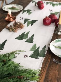 the table is set with apples, candles and other holiday decorations on top of it