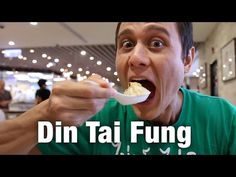 a man eating food from a spoon with the words din tai fung on it