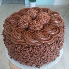 a cake with chocolate frosting on top sitting on a table